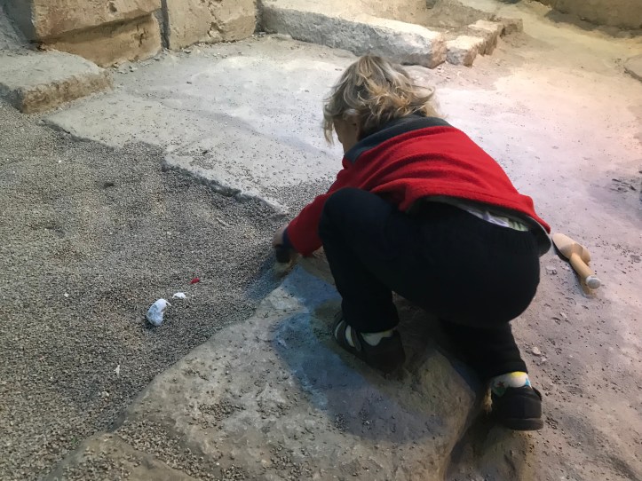 DS threw several fits as all he wanted to do was sit in the jeep at the front rather than see anything else. Him and his vroom vrooms. The ground floor was about life in ancient times. There were sections on building temples, growing crops, bartering at a market, dressing up as Pharoah and more. There were also videos and interactive screens, but we skipped those due to the kids' ages. Crop growing didn't interest them, but DD enjoyed building the temple statues a bit. It was like giant building blocks. The market area had a bunch of produce and some large donkey and cow figurines that she enjoyed feeding. There was also a balance scale that we used to confirm which fruit weighed more. The dress up area was fun, though I think it was designed to have more to it as signs indicated dressing up in full costumes. There were fancy hats and various staffs which occupied the kids. DD loved pretending to be a queen and DS marched around with a staff and hat on.