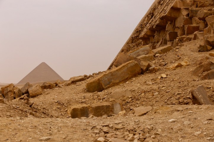 The Red pyramid in the background with a portion of the Bent Pyramid visible up close